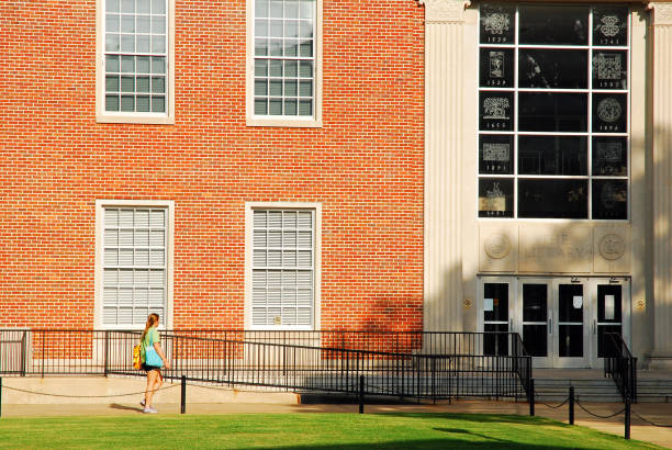 A female student walks on campus at the University of Mississippi Oxford, MS, USA July 21, 2010 A student heads towards the science building on the campus of the University of Mississippi in Oxford, Mississippi oxford mississippi photos stock pictures, royalty-free photos & images
