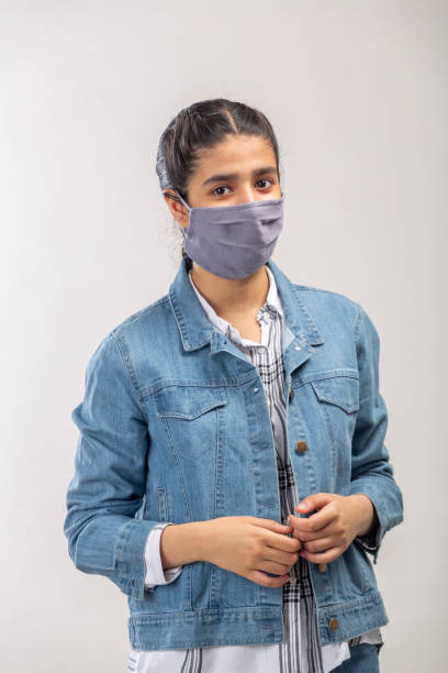 istock an Indian girl with protective mask on her face 1216009640