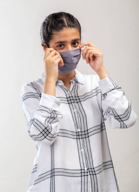 istock an Indian girl with protective mask on her face 1216009715