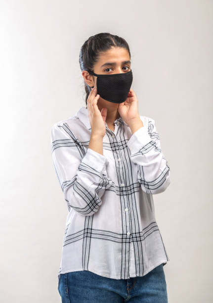 istock an Indian girl with protective mask on her face 1216010060