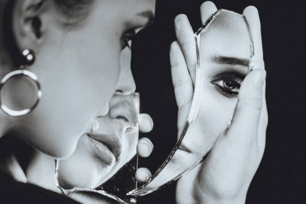 istock Woman with broken self-image mirror on black background, black and white portrait 1216010164