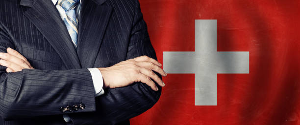 politico ha incrociato le braccia di sullo sfondo della bandiera svizzera - crossing human arm leadership men foto e immagini stock