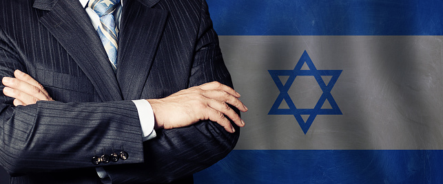 Male arms crossed on Israel flag background