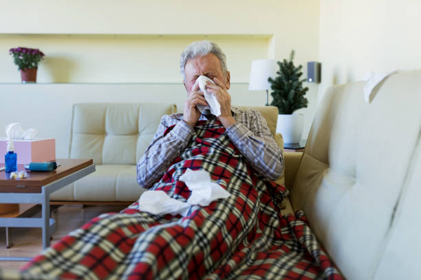 istock Senior coughing and having the flu 1216011351