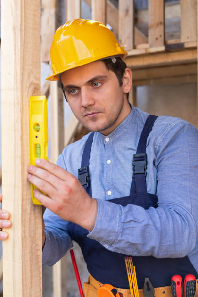 istock Carpenter measuring lumber with spirit level 1216013005