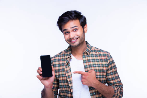 istock Young man showing a phone stock photo 1216013159