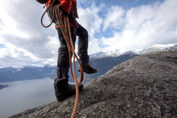 istock Mountaineer walks along mountain ridge with climbing rope 1216013429