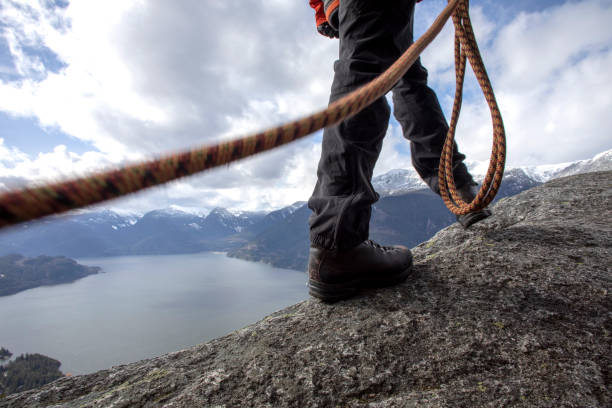 istock Mountaineer walks along mountain ridge with climbing rope 1216013494