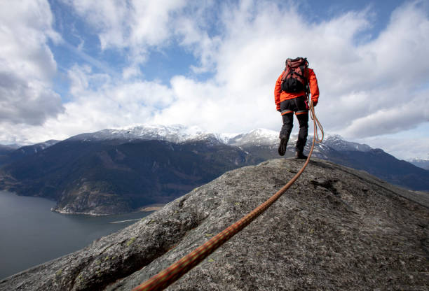 istock Mountaineer walks along mountain ridge with climbing rope 1216014381
