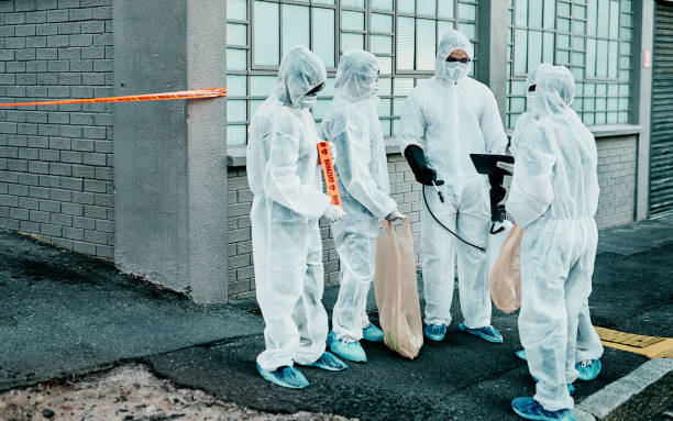 What the world looks like today Shot of a group of healthcare workers wearing hazmat suits working together during an outbreak in the city biohazard cleanup stock pictures, royalty-free photos & images