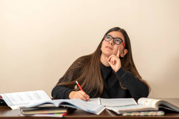 istock 13 years old girl doing homework at home 1216015083