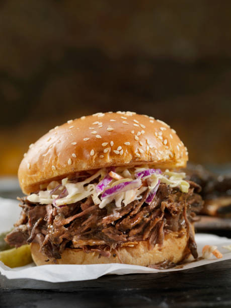Braised Beef Short Rib Sandwich with Coleslaw on a Brioche Bun Braised Beef Short Rib Sandwich with Coleslaw on a Brioche Bun barbecue beef stock pictures, royalty-free photos & images