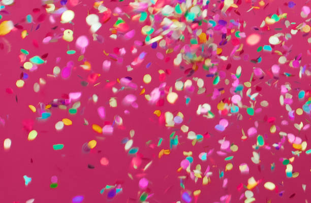 istock Colorful confetti falling on pink background 1216015306