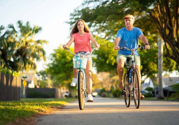istock Father and daughter on bikes 1216017605