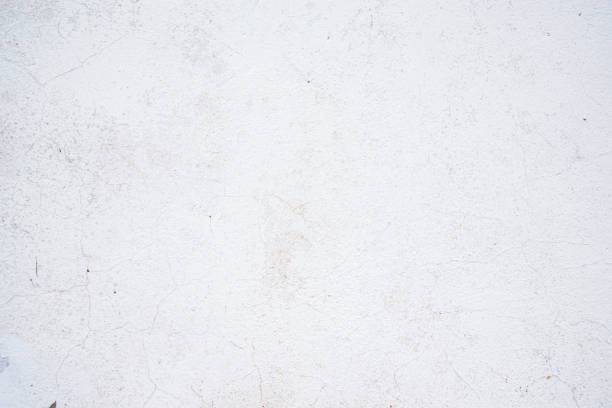 istock Texture of old cracked paint on the wall. White background for text or design 1216019125