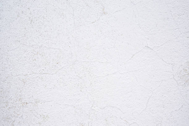 istock Texture of old cracked paint on the wall. White background for text or design 1216019136