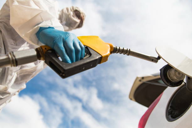 istock Gas station worker refilling car at service station 1216019274