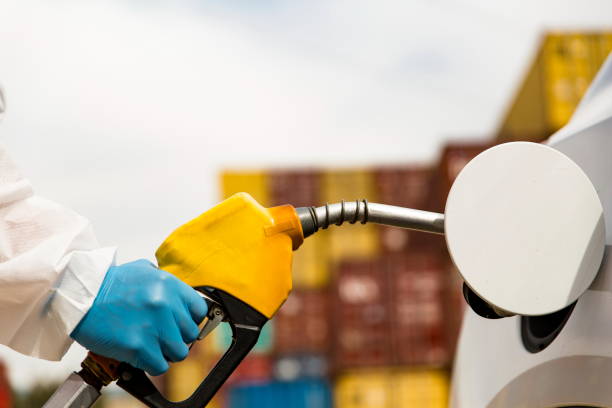 istock Gas station worker refilling car at service station 1216019494