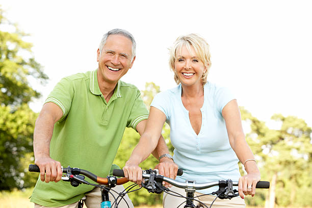 istock Mature couple riding bikes 121601988