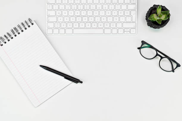 istock White office desk table with, computer keyboard  glasses, cup of coffee and other office supplies. Top view with copy space, flat lay. 1216021071