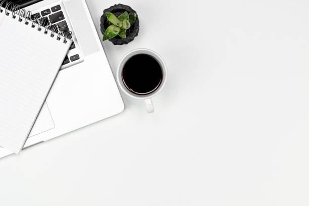 istock White office desk table with, computer keyboard  glasses, cup of coffee and other office supplies. Top view with copy space, flat lay. 1216021220