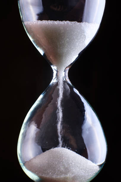 istock Hourglass close-up on a dark background. 1216021435
