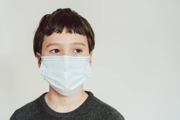 istock Young boy wearing fact mask during Covid-19 crisis 1216021557