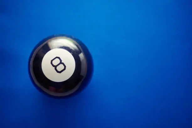 A ball of predictions with answers to questions on a blue background.