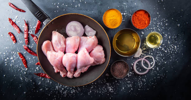istock Raw chicken, fish and spices on the table top in the kitchen. 1216022358