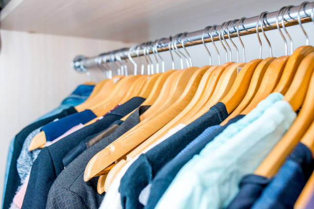 istock Lot of different clothes on hangers. Copy space 1216022929