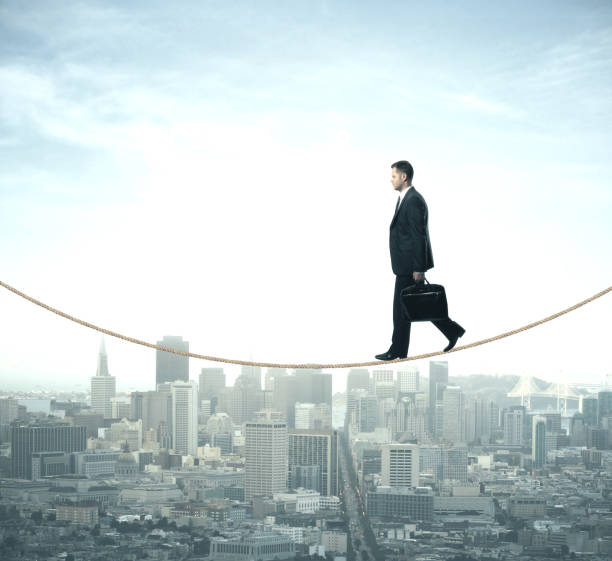 istock Businessman walking on rope 1216023066