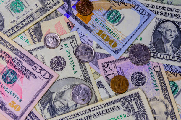 istock Different american cent coins over the dollar banknotes 1216023143