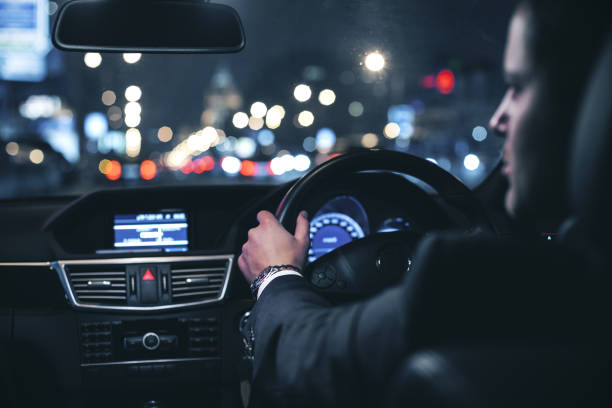 istock Businessman driving car at night 1216024004