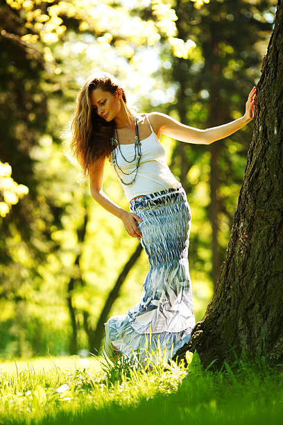 istock girl standing next to a tree 121602420