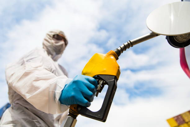 istock Gas station worker refilling car at service station 1216024324