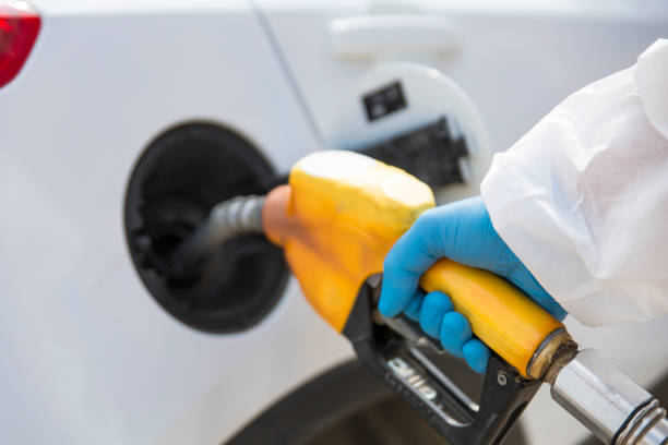 istock Gas station worker refilling car at service station 1216024328