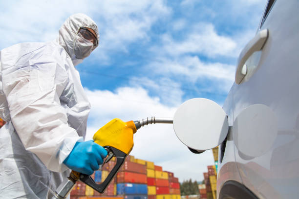 istock Gas station worker refilling car at service station 1216024349