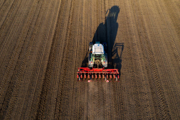 istock Tractor Sowing Field, Aerial View 1216025784