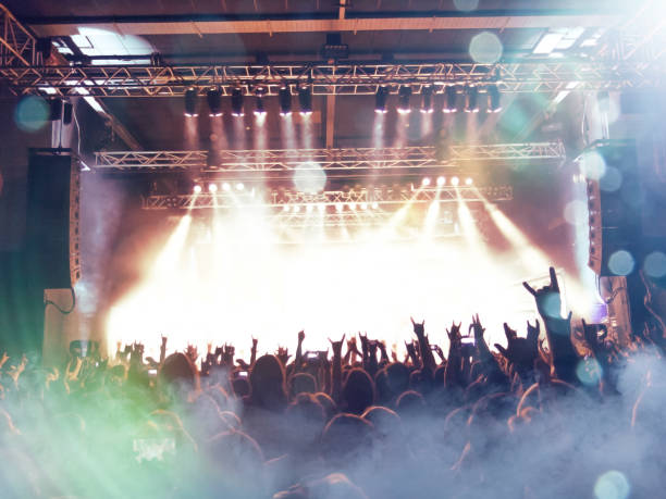 istock Concert hall with people silhouettes 1216025804
