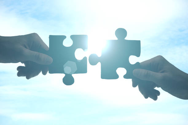 istock Hands putting puzzle pieces together 1216027674