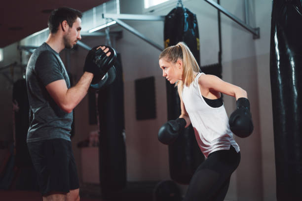 istock Fit female boxer sparring with her trainer 1216029049