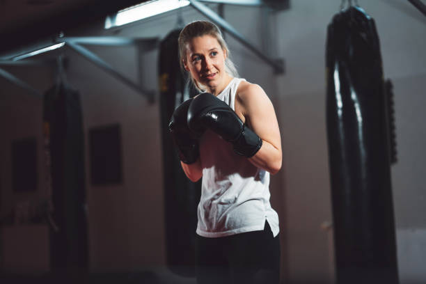 istock Blonde caucasian female boxer holding a boxing pose 1216029073