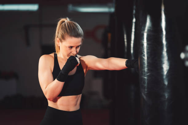istock Young adult woman training box 1216029109
