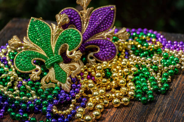 A frame of three colors of Mardi gras beads on white background.