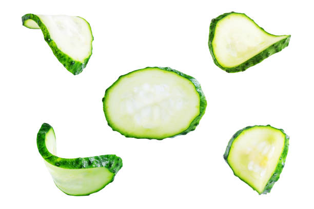 Fresh cucumber on a white isolated background Fresh cucumber on a white isolated background. toning. selective focus cucumber slice stock pictures, royalty-free photos & images