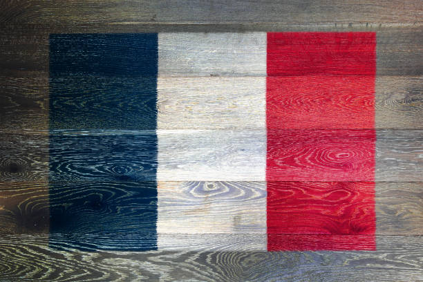 istock France flag on rustic old wood surface background 1216034553