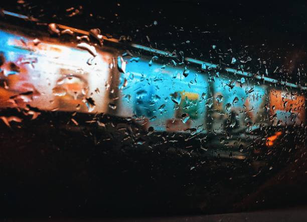 istock Focus on raindrops in the car window at night 1216034667