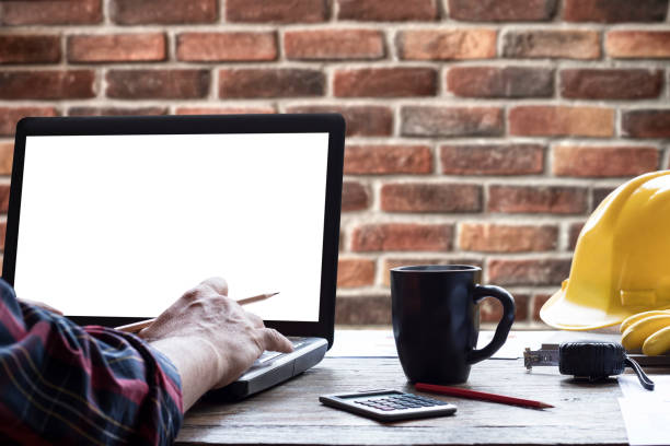 istock worker using laptop and cup of coffee on wooden table 1216036768