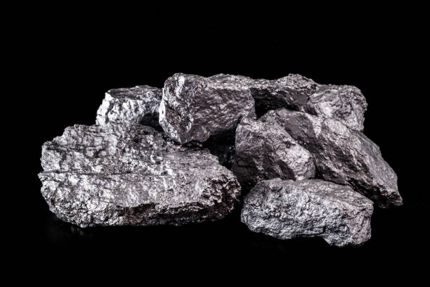 istock large silver nugget on black background. Raw silver stone, silver nugget native to Liberia, isolated on black background. Mineral extraction. 1216037038