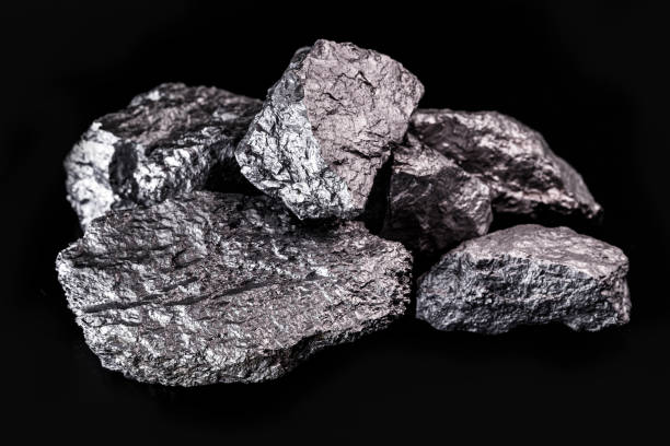 istock large silver nugget on black background. Raw silver stone, silver nugget native to Liberia, isolated on black background. Mineral extraction. 1216037042